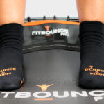 person bouncing on fit bounce pro rebounding in grip socks