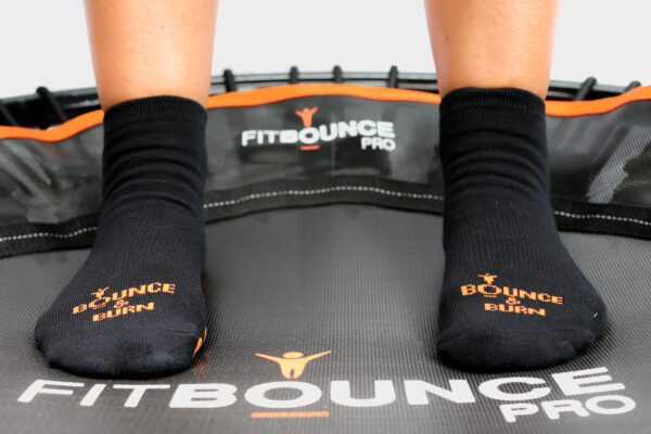 person bouncing on fit bounce pro rebounding in grip socks